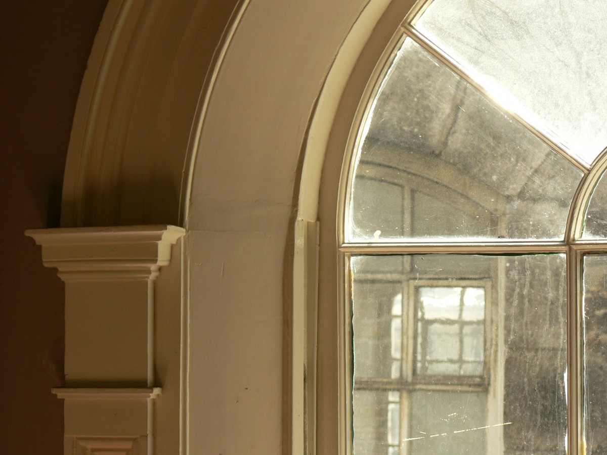 Restored arched stairwell window 