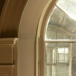 Restored arched stairwell window 